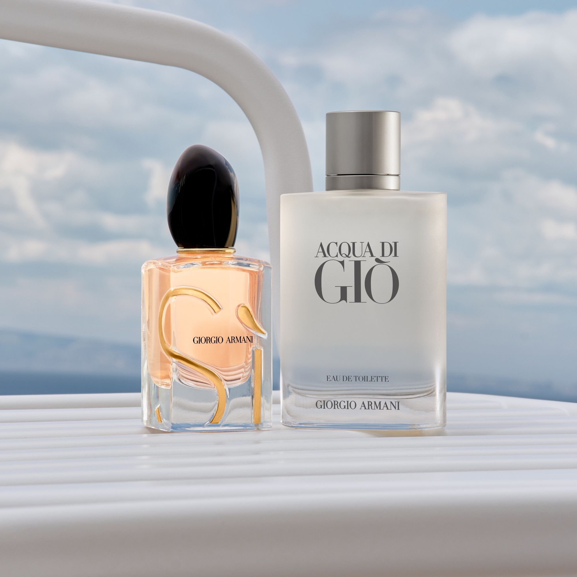 Un duo sofisticado de iconos de Armani: el radiante Si y el fresco Acqua di Gio. Sobre la barandilla de un yate blanco frente a un mar sereno, encarnan una elegancia eterna y el espiritu de una lujosa escapada costera.