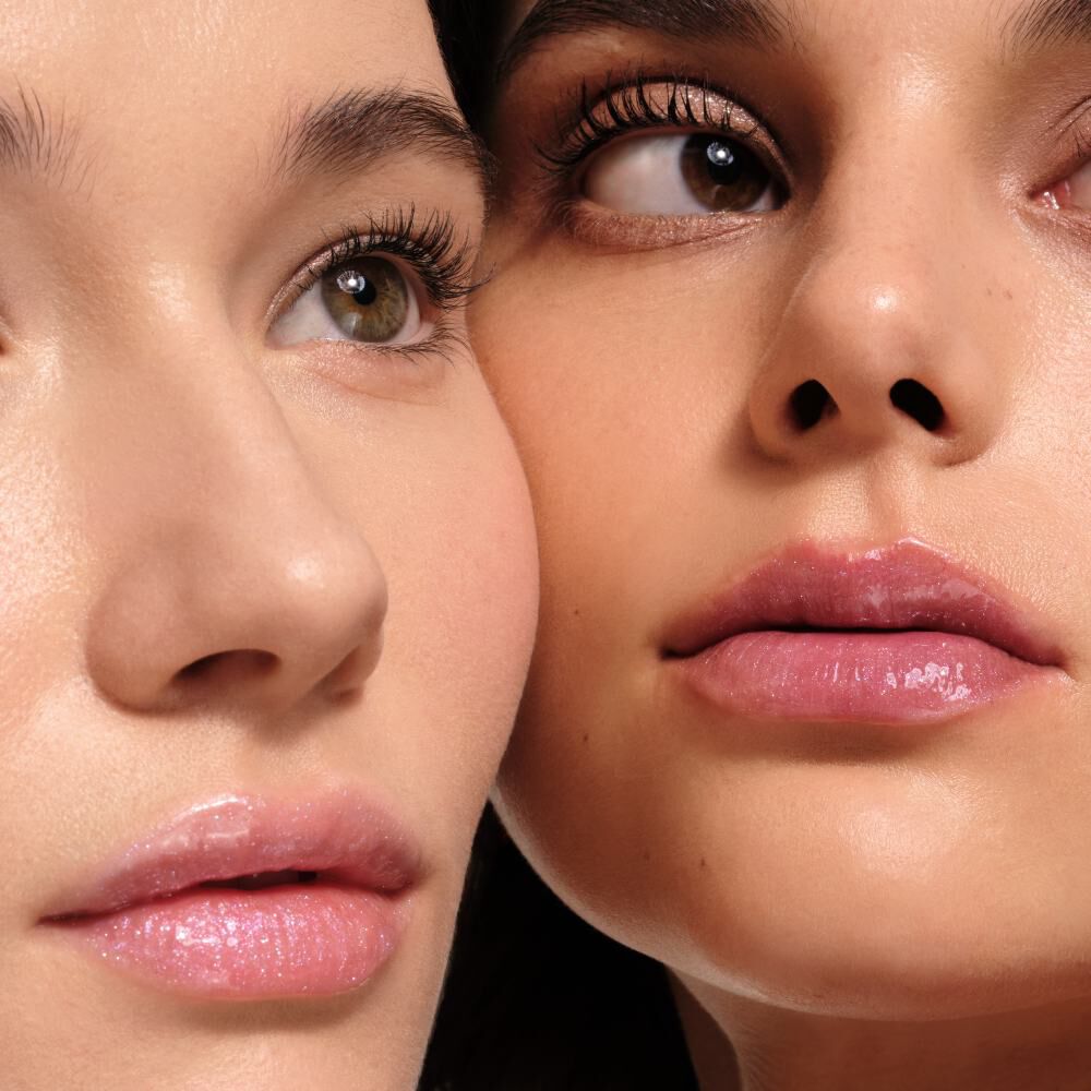 Two close-up portraits of young women, showcasing natural makeup with glossy lips and vibrant eye colors, emphasizing their features.