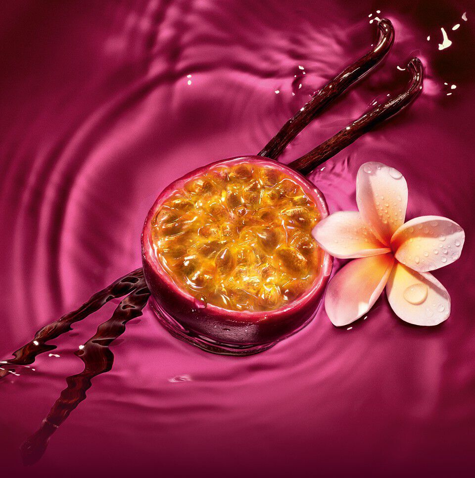 Maracuja (Passion fruit), vanilla beans, and frangipani flower floating in the radiant ruby liquid of the ARMANI POWER OF YOU perfume.