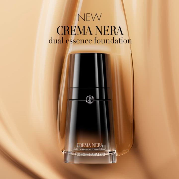 A sleek bottle of Giorgio Armani's Crema Nera dual essence foundation is displayed against a smooth, beige background, highlighting the product's elegance and sophistication.