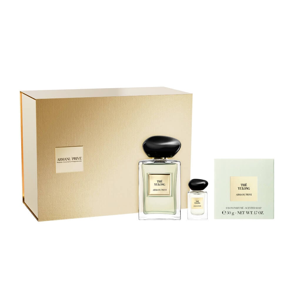 Armani Prive Les Eaux The Yulong Holiday gift set on white background: gold box beside the eau de parfum bottle, a miniature and a candle.