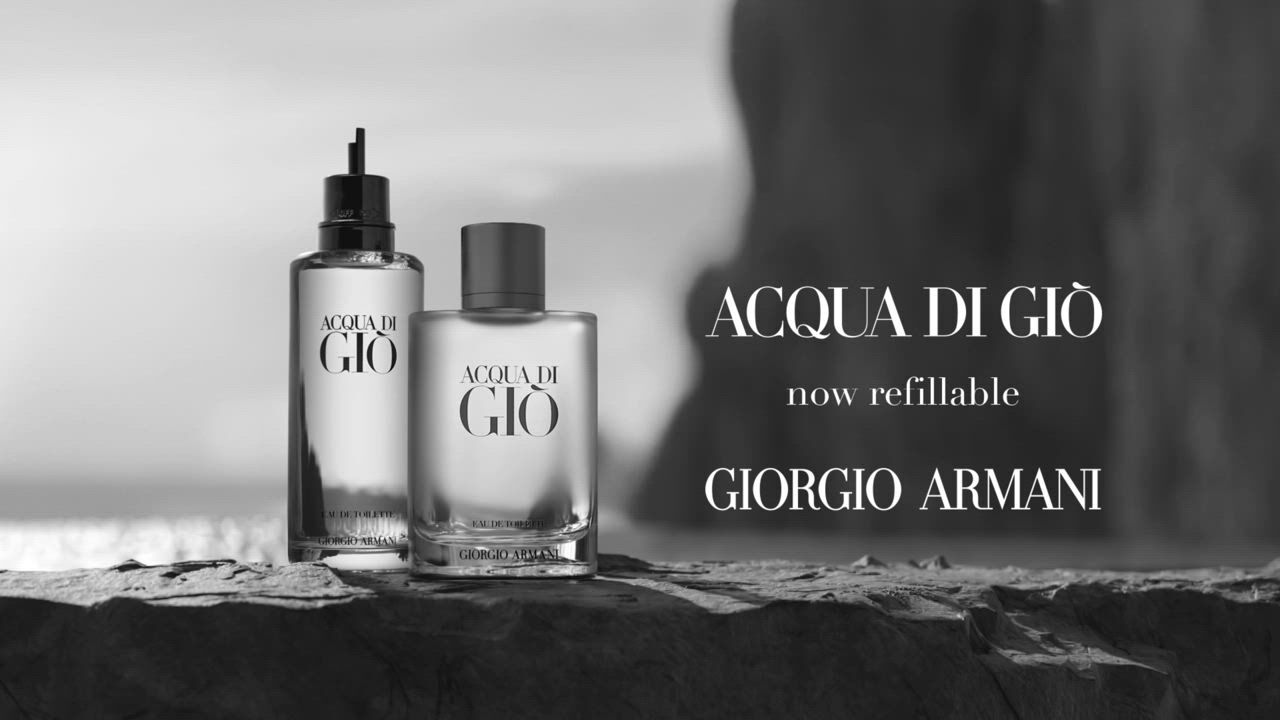 Two bottles of Acqua di Giò fragrance by Giorgio Armani, highlighting the 'now refillable' feature against a rocky backdrop.